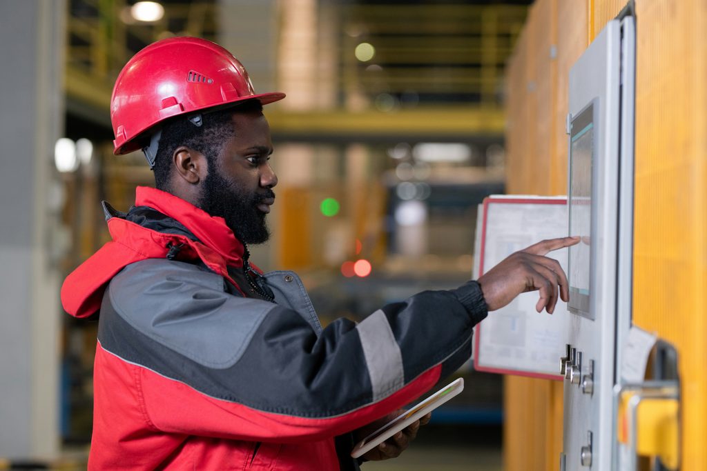 A certified fire alarm specialist reviewing the fire alarm system panel.